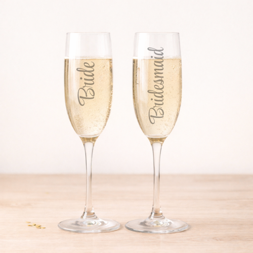two flutes with engraved bride and bridesmaid 