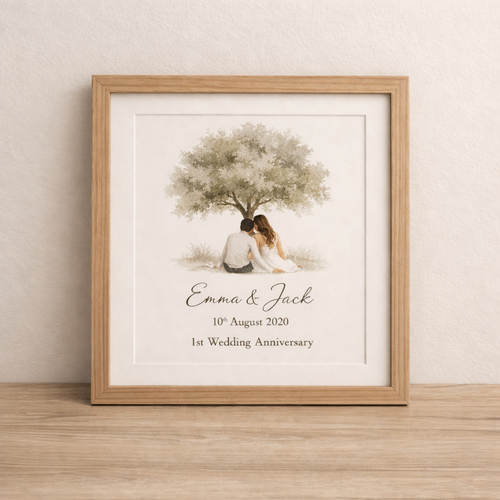 print of couple sitting in front of a tree on first wedding anniversary