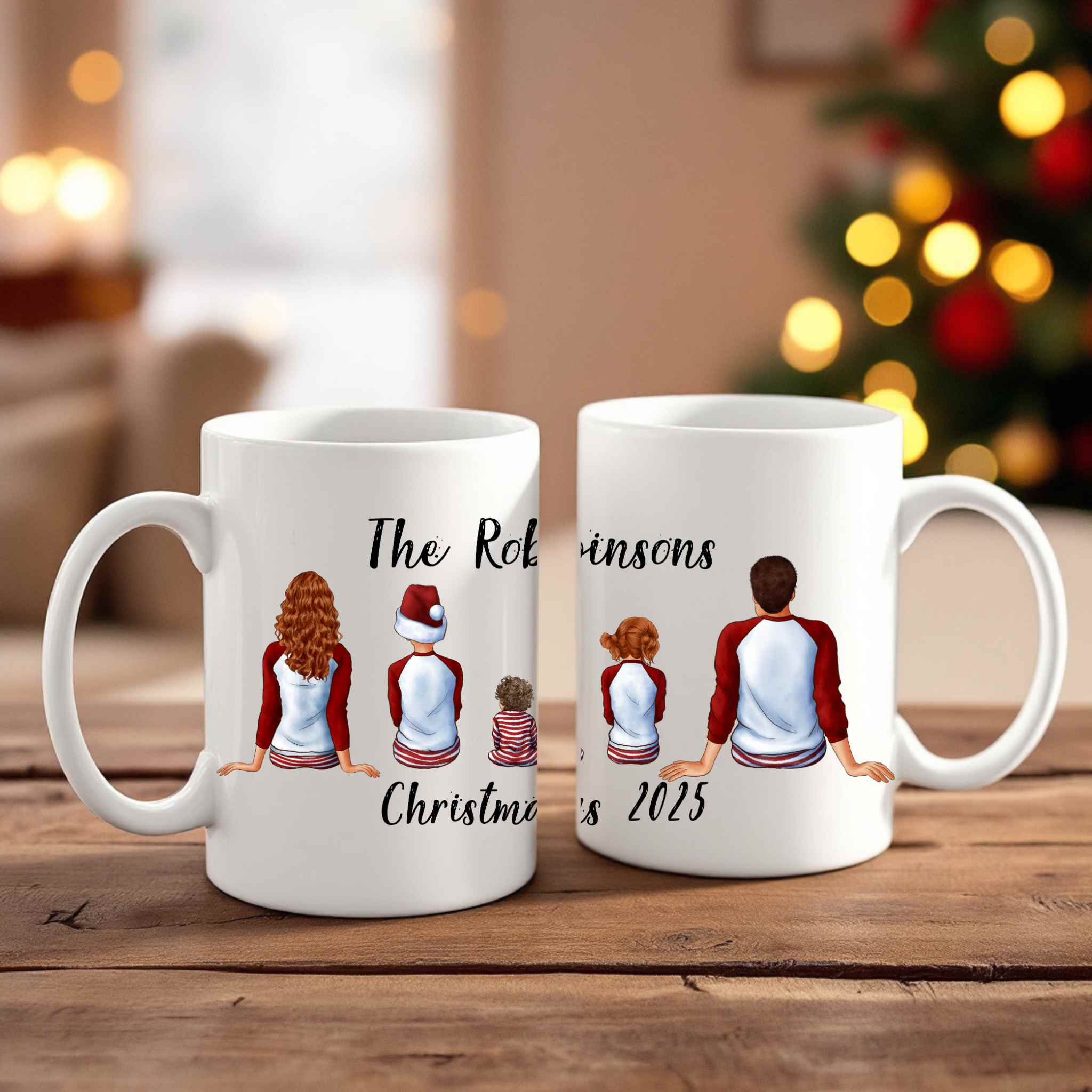 Personalised clipart Christmas-themed mugs with family illustrations on a wooden surface, blurred festive background.